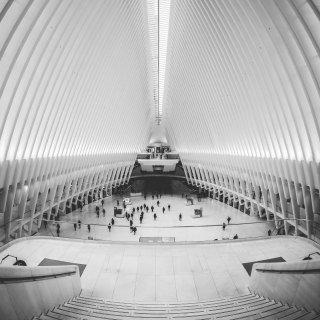 A big building with interleaving architecture and many people walking inside